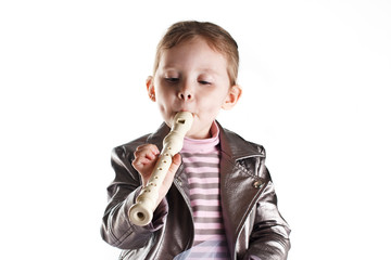 Portrait of a toddler girl playing on flute © Roman