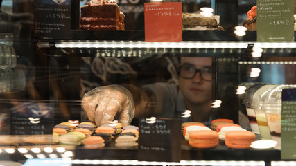 Man serving pasty from window case