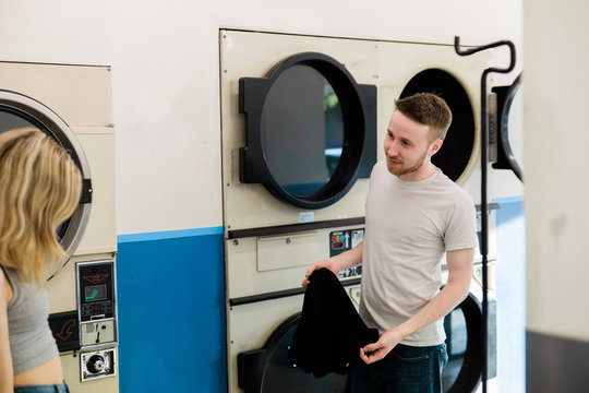 male and female doing laundry together
