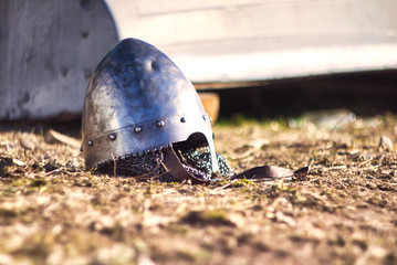 Medievil steel helmet with rivets lying on the ground