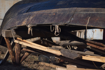 Wooden historical Viking Boat ashore dries inverted