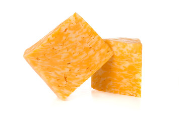 Marble cheese on a white background. Two triangles of cheese close up.