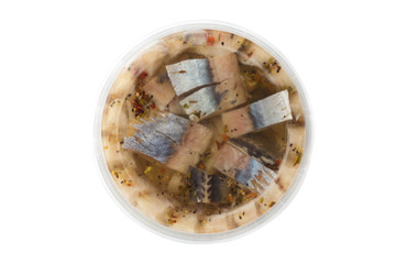 Marinated fish in a plastic container. Pieces of pickled herring in the package from the store on a white background.