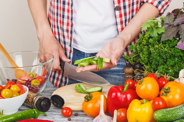 Woman cooks at the kitchen, body part, blurred background