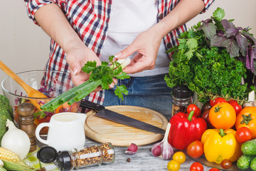 Woman cooks at the kitchen, body part, blurred background