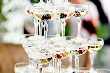 glasses of champagne with a frozen berries outside