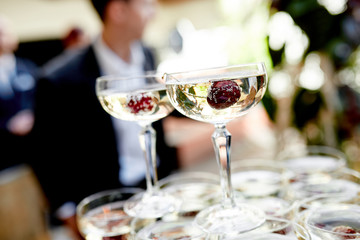 glasses of champagne with a frozen berries outside