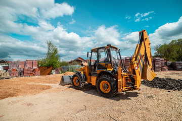 Obraz na płótnie Canvas Yellow bulldozer excavator on the construction site working machine