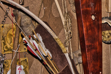 Bow and arrows and psaltery hang on the wall. Background.