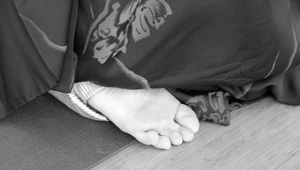 Soft photo of woman feet under cloth on floor yoga position