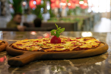 Pizza on black stone background, top view. Pizza with Tomatoes, Basil and Mozzarella Cheese close up