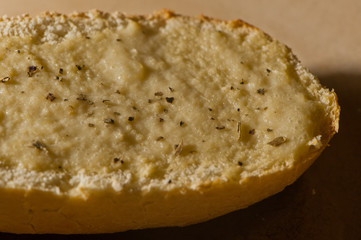 Slice of vegan, oil-free, whole-food plant-based garlic spread on baguette