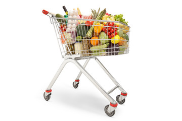 Shopping trolley filled with different food products, fruits and vegetables