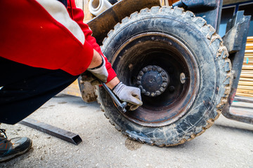 Close up on the fork lifter flat tire replacement © Miljan Živković
