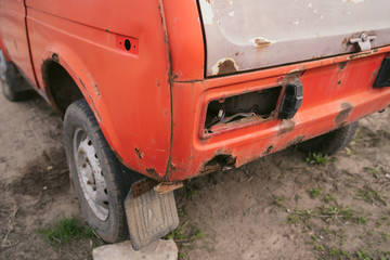 Car  after collision. A close up of a broken car after a traffic accident. Crumpled side of a car as a result of a clash. 