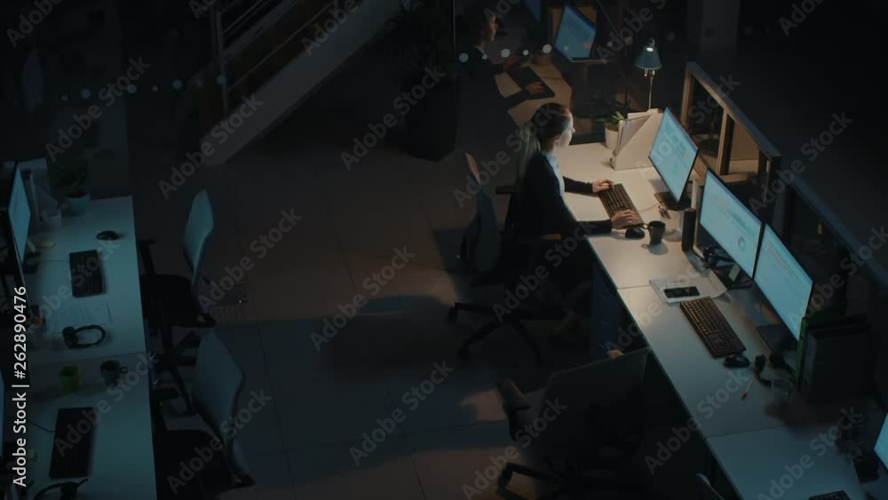 Poster working late at night in the office: businesswoman using desktop computer, having discussion, analyz