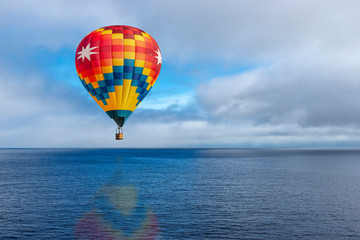 Hot balloon over calm ocean