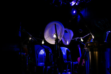 White hat, musical instrument, blue shadows and other sizes dark background.