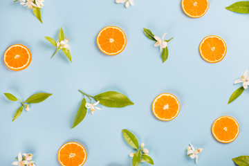 Oranges and flowers, top view.