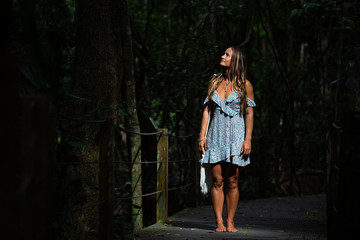 Pretty woman in dark ethereal rainforest
