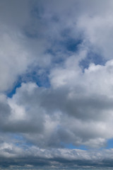 blue sky with grey and white clouds portrait orientation
