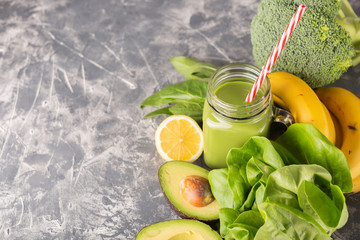 Green smoothie in moody dark background