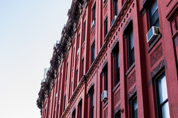 Red facade of a typical Harlem brownstone building, Manhattan, New York City, USA