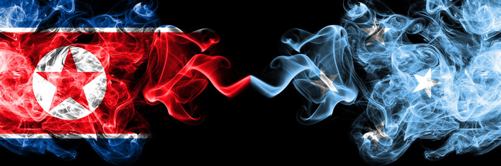 North Korea vs Micronesia, Micronesian smoky mystic flags placed side by side. Thick colored silky smoke flags of North Korea and Micronesia, Micronesian.