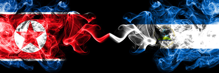 North Korea vs Nicaragua, Nicaraguan smoky mystic flags placed side by side. Thick colored silky smoke flags of North Korea and Nicaragua, Nicaraguan.