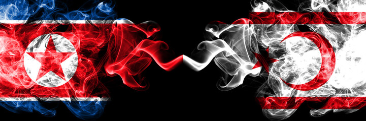 North Korea vs Northern Cyprus smoky mystic flags placed side by side. Thick colored silky smoke flags of North Korea and Northern Cyprus.