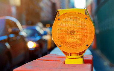 Orange traffic barrier barrels to detour traffic around construction zone shallow depth