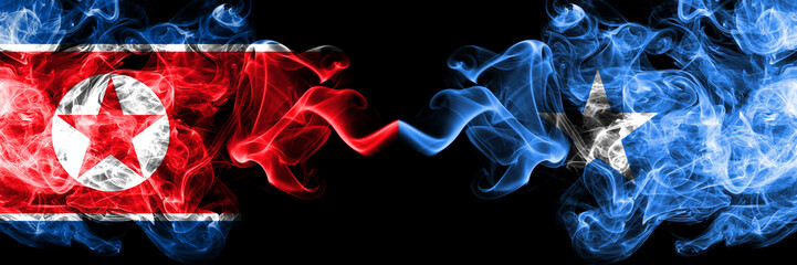 North Korea vs Somalia, Somalian smoky mystic flags placed side by side. Thick colored silky smoke flags of North Korea and Somalia, Somalian.