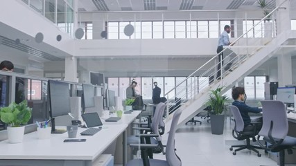 In Modern Office: Diverse Team of Managers and Specialists Work on Computer, Have Discussion with Colleagues and on the Phone. Young and Motivated Business people in Open Office.