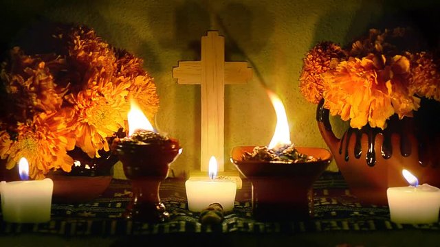 Day of the dead offering altar looped footage with cempasuchil flowers, burning copal and candles. Essential part of Day of the Dead festivities in Mexico. 