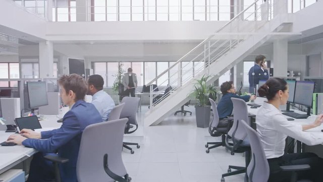 In Modern Office: Diverse Team of Managers and Specialists Work on Computer, Have Discussion with Colleagues and on the Phone. Young and Motivated Business people in Open Office.