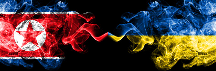 North Korea vs Ukraine, Ukrainian smoky mystic flags placed side by side. Thick colored silky smoke flags of North Korea and Ukraine, Ukrainian.