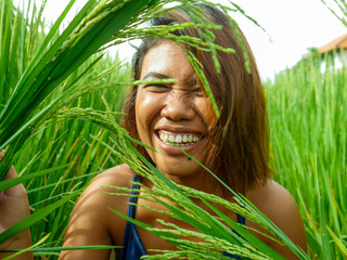 natural and fresh portrait of young happy and exotic islander Asian girl from Indonesia smiling...