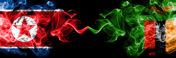 North Korea vs Zambia, Zambian smoky mystic flags placed side by side. Thick colored silky smoke flags of North Korea and Zambia, Zambian.