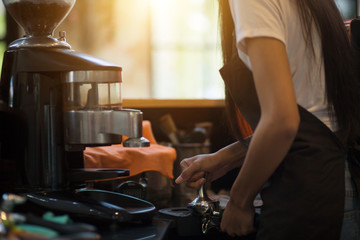 Employees working with coffee makers.