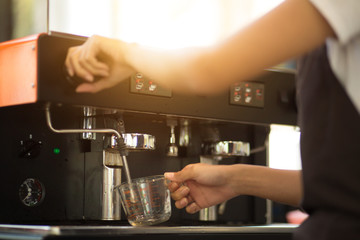 Employees working with coffee makers.