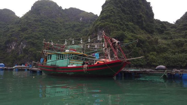 Fishing vessel, Halong Bay, Vietnam, floating water village, large lights on board to attract fish at night