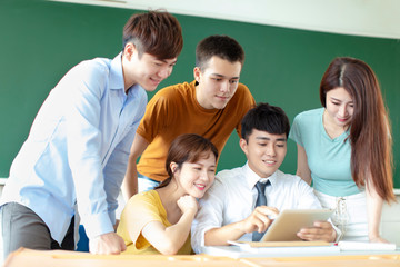 teacher with group of college students in classroom