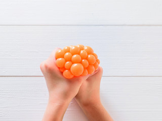 The child crushes the toy with his hands against stress.