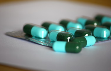 green-blue antibiotic capsule pills in blister pack
