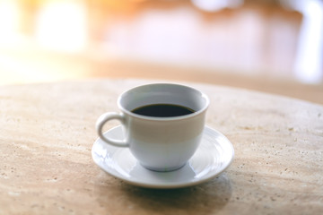 A white mug of hot coffee on the table