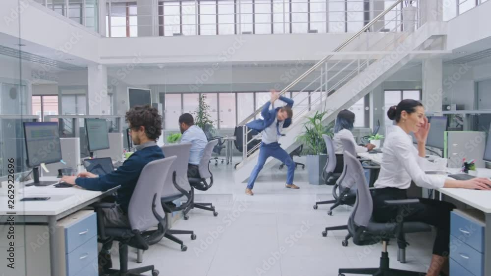 Aufkleber young cheerful handsome business manager wearing a suit and tie is dancing like crazy in the office.