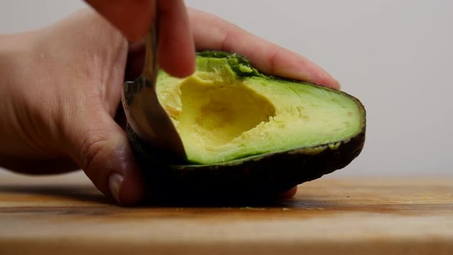 Cutting open an avocado.