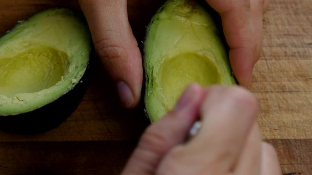 Removing the pit from an avocado.