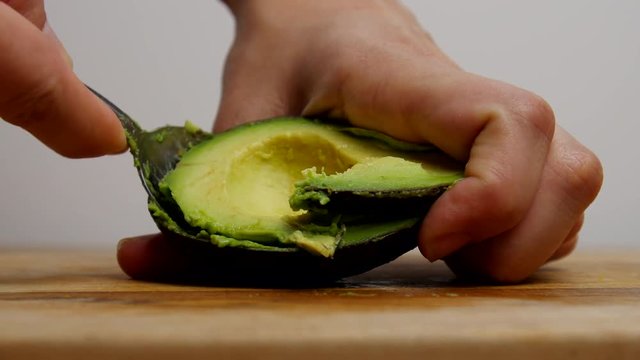 Cutting open a ripe avocado.
