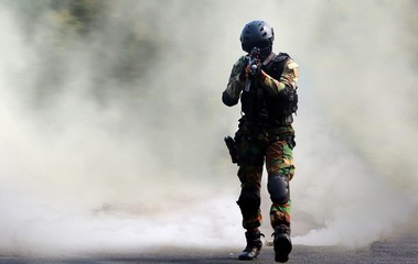 Special force assault under smoke screen background